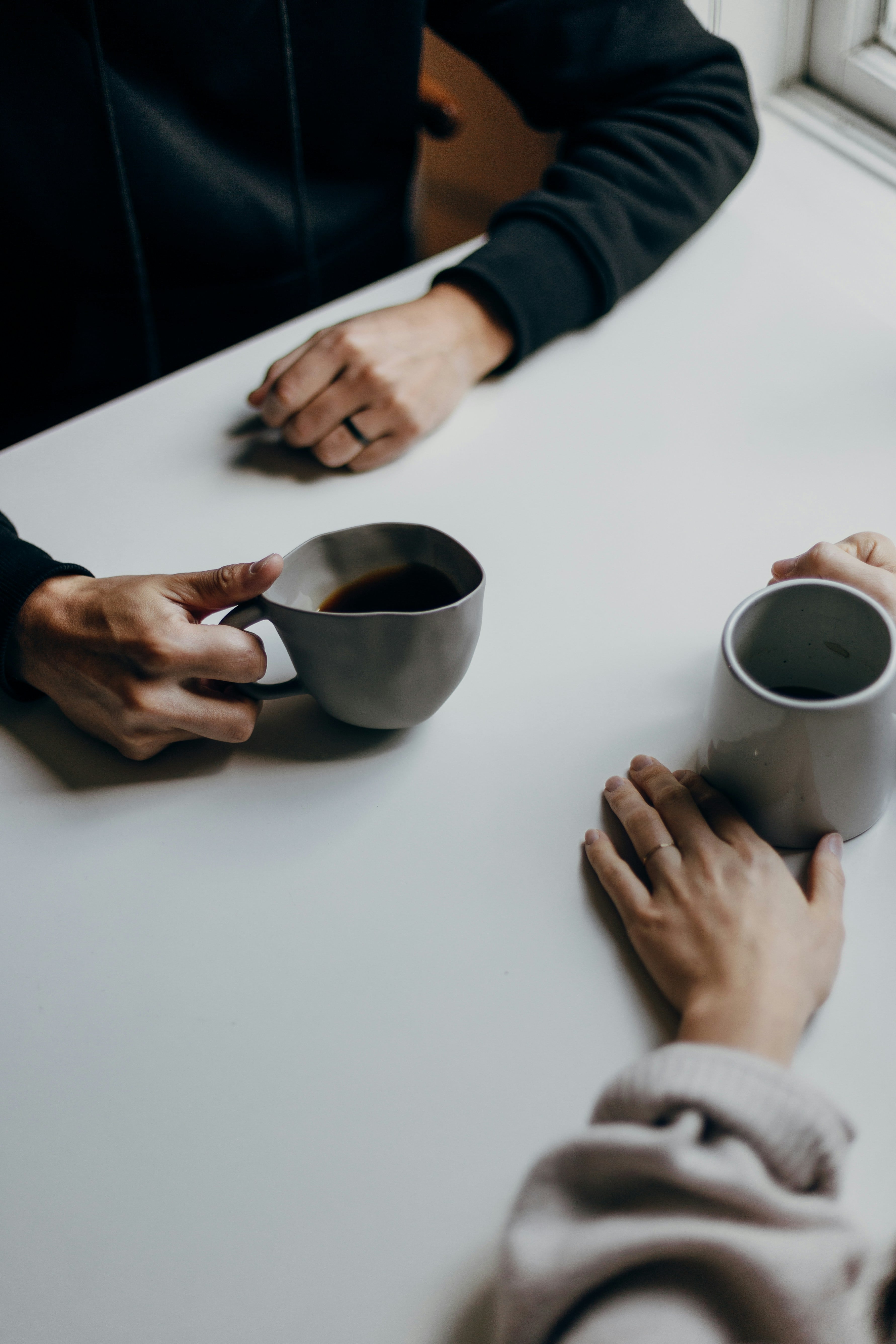 Two people sharing coffee in conversation